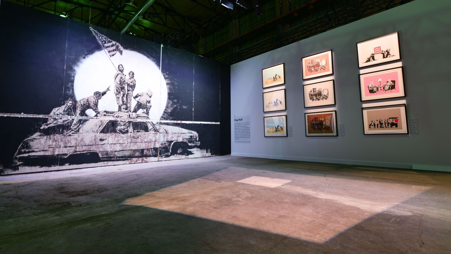 “The Art of Banksy” exhibit features “Flag Wall” among 80 works created by the mysterious artist.